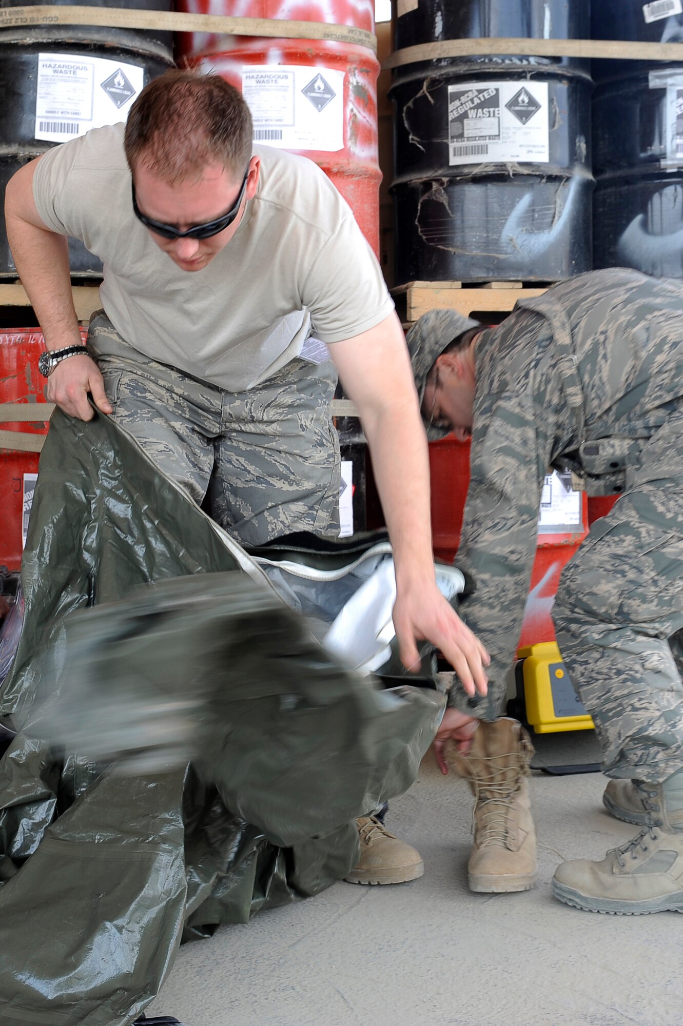 U.S. Air Force Senior Airman Michael Gilbert, 455th Expeditionary Medical Operations Squadron puts on a chemical protection suit during a hazardous materials exercise at Bagram Airfield, Afghanistan, April 29, 2010. Airman Gilbert is deployed from Nellis Air Force Base, Nev., and is from Exeter, Calif. (U.S. Air Force photo by/ Master Sgt. Jeromy K. Cross/released)