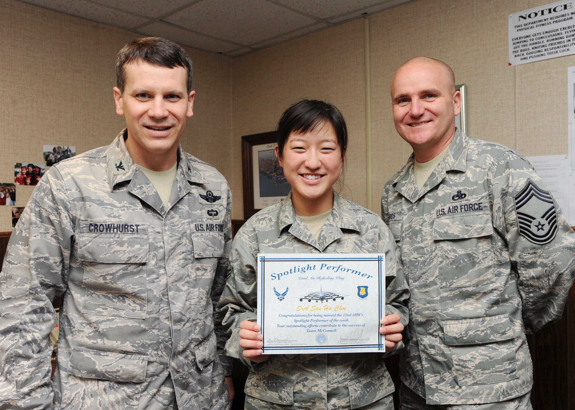 (From left to right) Col. James Crowhurst, 22nd Air Refueling Wing commander, Airman 1st Class San Ha Choe, 22nd Maintenance Operations Squadron maintenance management analyst, and Chief Master Sgt. Michael Edwards, acting 22nd ARW command chief, pose for a picture after presenting Airman Choe a certificate acknowledging her as the 22nd MOS spotlight performer. Airman Choe has served in the Air Force for more than two years and has been stationed at McConnell since completing her technical training in 2008.