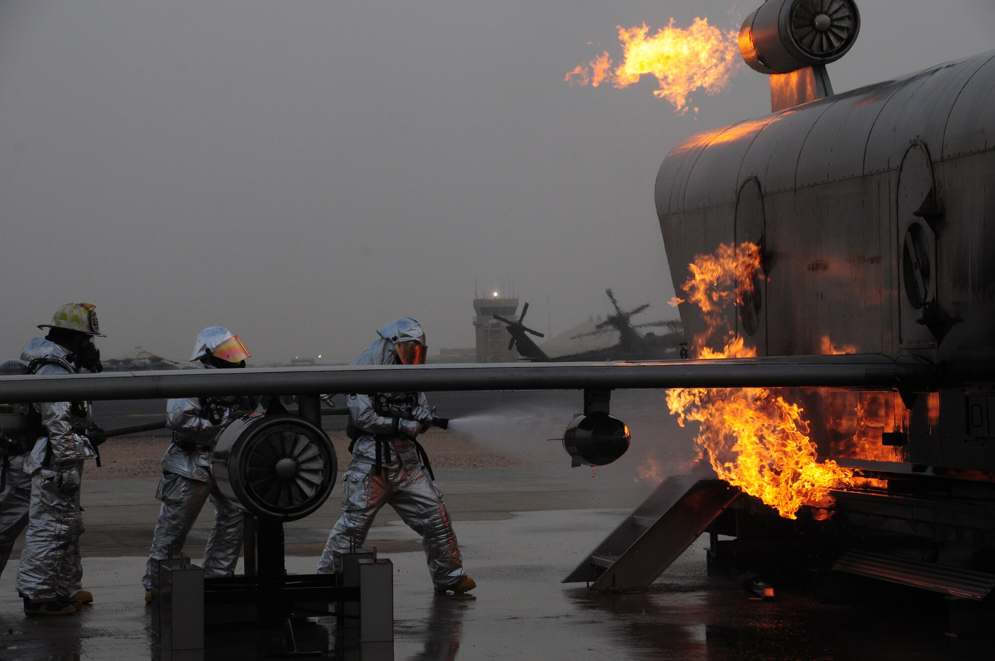 U.S. Air Force firefighters with the 386th Expeditionary Civil Engineer Squadron rush to the scene of a burning aircraft during live fire training at a nearby base in Southwest Asia April 29, 2010. Live fire training is an annual requirement all firefighters must complete in order to stay proficient. (U.S. Air Force photo by Staff Sgt. Lakisha A. Croley/Released)
