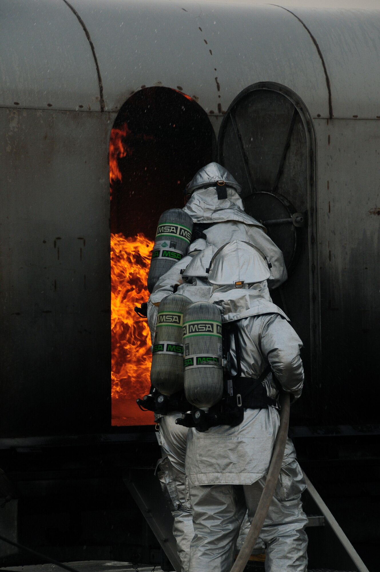U.S. Air Force firefighters with the 386th Expeditionary Civil Engineer Squadron practice extinguishing an aircraft fire at a nearby base in Southwest Asia April 29, 2010. Live fire training is an annual requirement all firefighters must complete in order to stay proficient. (U.S. Air Force photo by Staff Sgt. Lakisha A. Croley/Released)