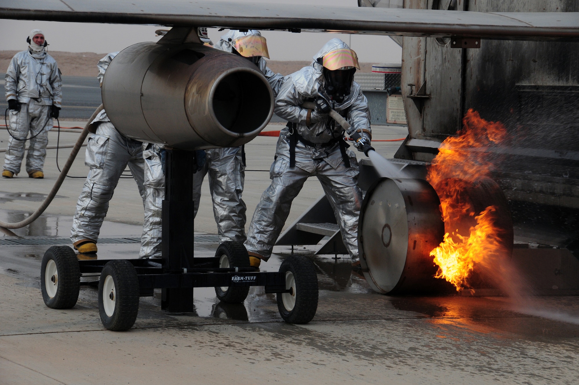U.S. Air Force firefighters with the 386th Expeditionary Civil Engineer Squadron complete live fire training at a nearby base in Southwest Asia April 29, 2010. Live fire training is an annual requirement all U.S. Air Force firefighters to ensure they stay proficient. (U.S. Air Force photo by Staff Sgt. Lakisha A. Croley/Released)