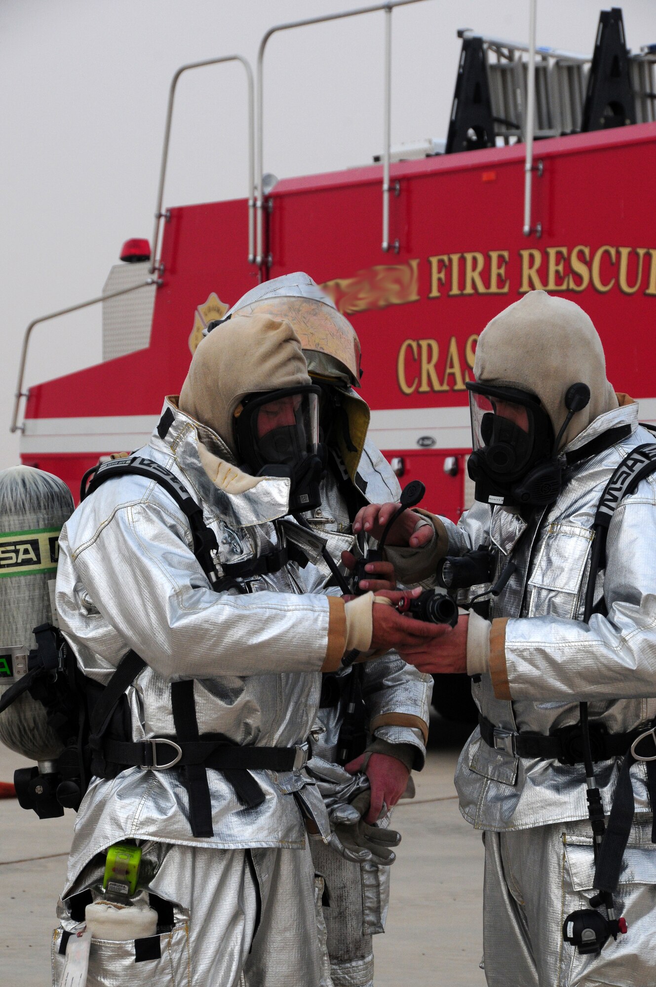 U.S. Air Force firefighters with the 386th Civil Engineer Squadron don their equipment in preparation for live fire training at a nearby base in Southwest Asia April 29, 2010. Live fire training is an annual requirement all U.S. Air Force firefighters to ensure they stay proficient. (U.S. Air Force photo by Staff Sgt. Lakisha A. Croley/Released)