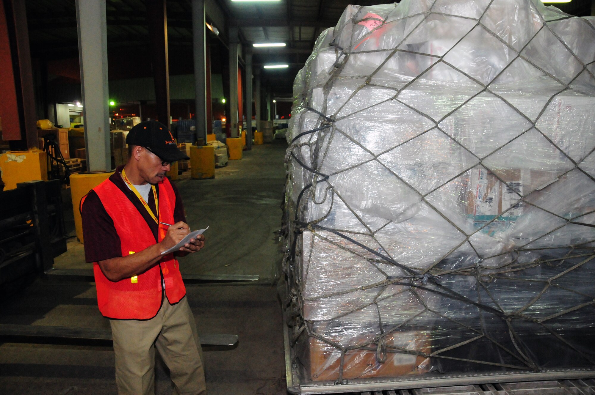 U.S. Air Force Tech. Sgt. Cornelious Barnett, 386th Expeditionary Communications Squadron mail control activity, records important information from a pallet of mail here April 27, 2010 at an undisclosed location in Southwest Asia. Sergeant Barnett, an Oklahoma City native, is deployed from the 72nd Aerial Port Squadron, Tinker Air Force Base, Okla. (U.S. Air Force photo by Staff Sgt. Lakisha A. Croley/Released)