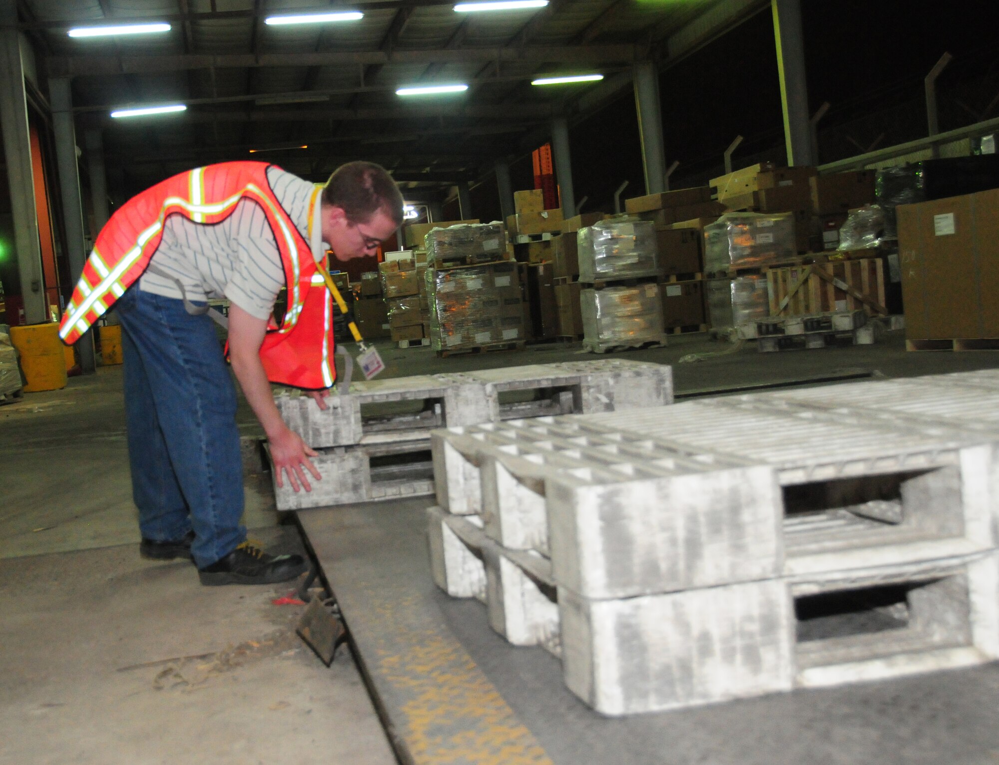 U.S. Air Force Senior Airman David Rudin, 386th Expeditionary Communications Squadron mail control activity, stacks pallets on a large scale in preparation to weigh outgoing U.S. mail here at an undisclosed location in Southwest Asia April 27, 2010. Airman Rudin is a Pensacola, Fla. native deployed from Detachment 2, Yokota Air Base, Japan.  (U.S. Air Force photo by Staff Sgt. Lakisha A. Croley/Released)