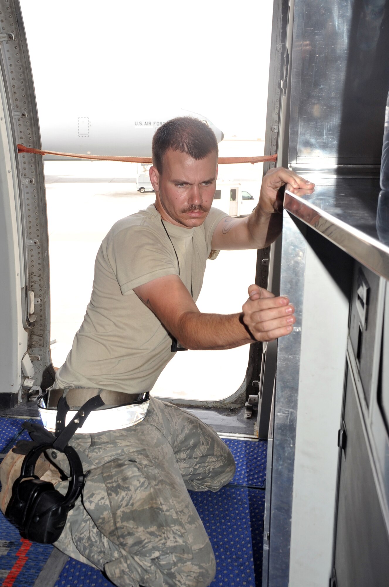 Airman 1st Class Brian Welch, KC-10 Extender crew chief with the 380th Expeditionary Aircraft Maintenance Squadron Extender aircraft maintenance unit, works on a KC-10 during operations for the 380th Air Expeditionary Wing at a non-disclosed base in Southwest Asia on April 24, 2010. Airman Welch is deployed from the 660th Aircraft Maintenance Squadron at Travis Air Force Base, Calif. (U.S. Air Force Photo/Master Sgt. Scott T. Sturkol/Released)