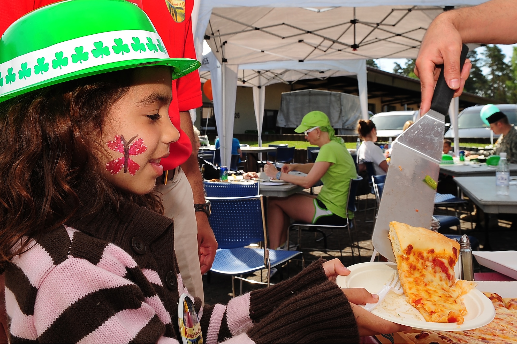 Emma Rios, daughter of U.S. Air Force Capt. Sergio Rios, 86th Services Squadron, is served a slice of pizza during a community event hosted by the 86th Services Squadron outside of the Northside Post Office, Ramstein Air Base, Germany, April 29, 2010. More than 150 members of the squadron volunteered their day setting up food booths, face-painting stands and a bouncy castle at the event to simply show gratitude to the community. (U.S. Air Force photo by Senior Airman Tony R. Ritter)