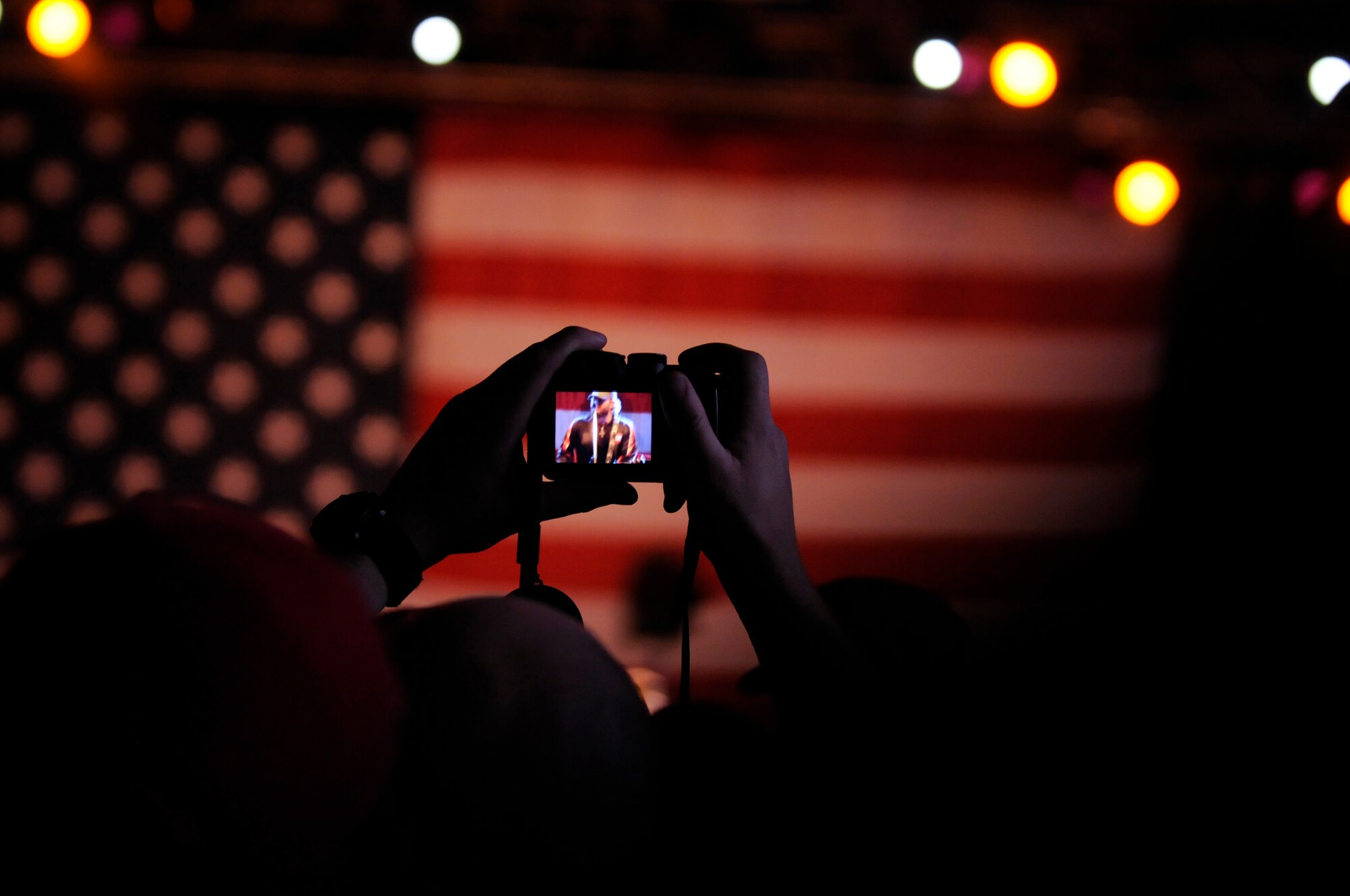 A fan takes a photo of Toby Keith, singer, songwriter and entertainer, while he performs in concert, Ramstein Air Base, Germany, May 1, 2010. The Toby Keith concert, sponsored by the United Services Organization and Armed Forces Entertainment, was designed to entertain and help boost the morale of troops and their families.  Toby Keith will be making stops throughout Germany, Korea and the Persian Gulf during his 14-day country tour. (U.S. Air Force photo by Airman 1st Class Brittany Perry)