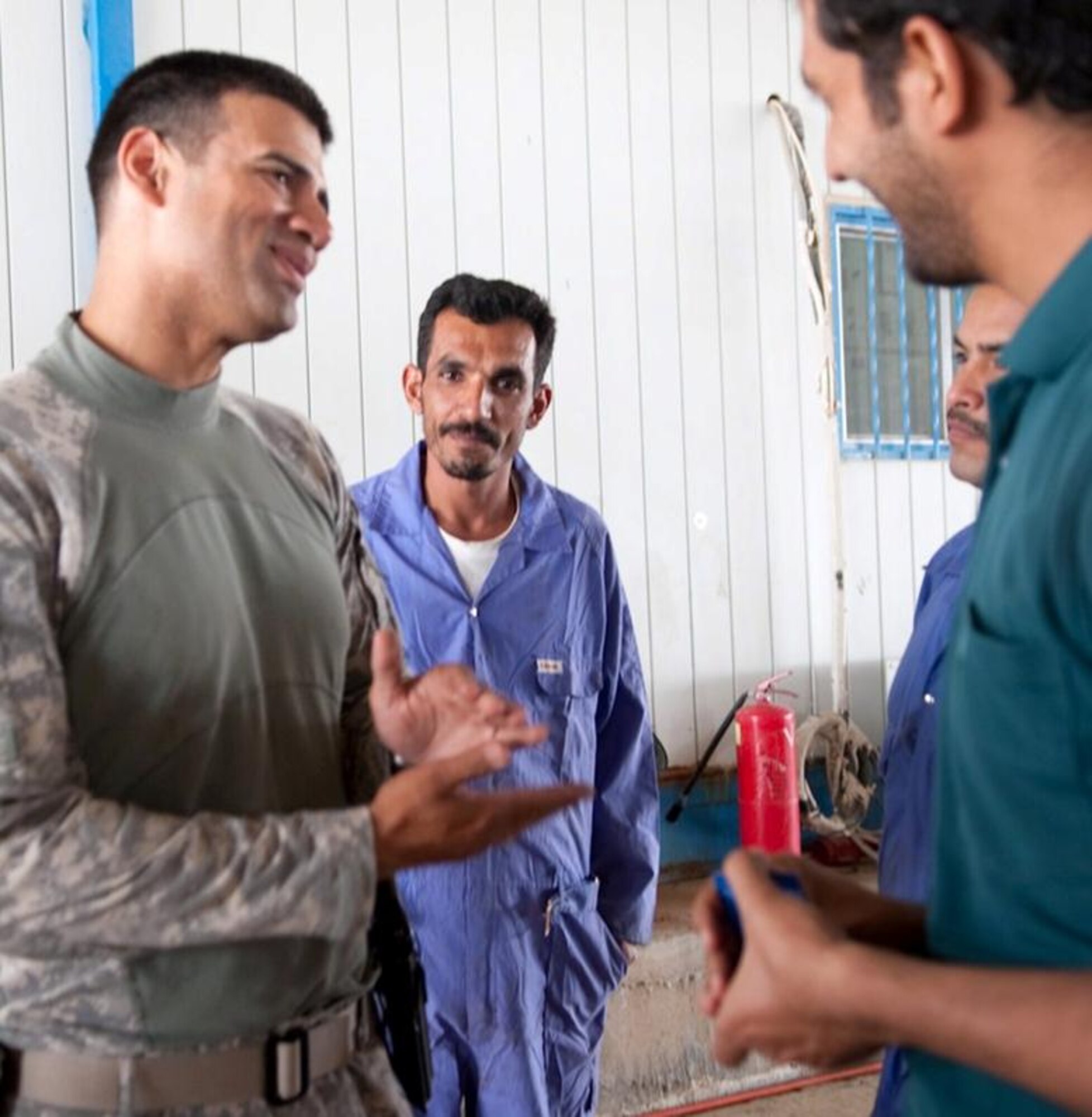 Tech. Sgt. Nelson Reyes, a member of the Logistics Military Advisory Team that facilitates training visits by Ali Base Airmen to Camp Ur, Iraq, discusses maintenance schedules with Iraq Army power production technicians April 20, 2010. (U.S. Air Force photo by Senior Master Sgt. Elizabeth Gilbert/released)
