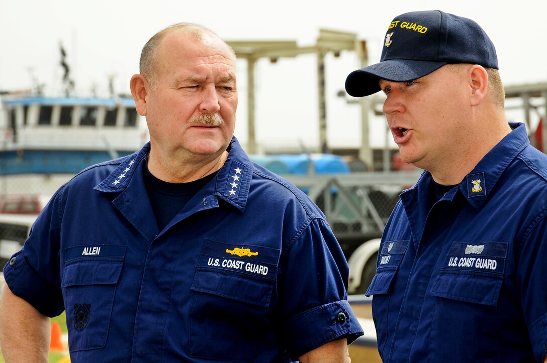 U.S. Coast Guard Master Chief Petty Officer Charles Bushey, officer-in-charge of Coast Guard Station Venice, La., briefs Coast Guard Commandant Adm. Thad Allen, left, before a visit by President Barack Obama in Venice, La., May 2, 2010.