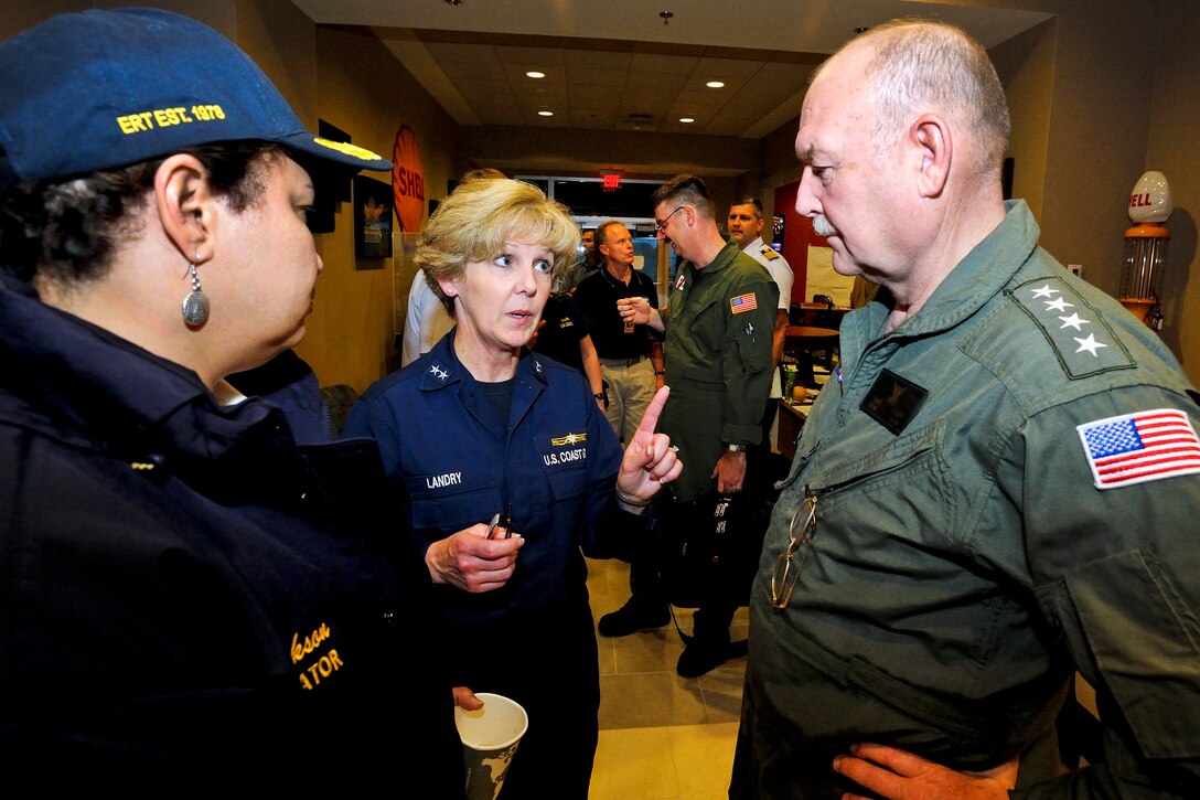 U.S. Coast Guard Rear Adm. Mary E. Landry, center, the federal on-scene ...