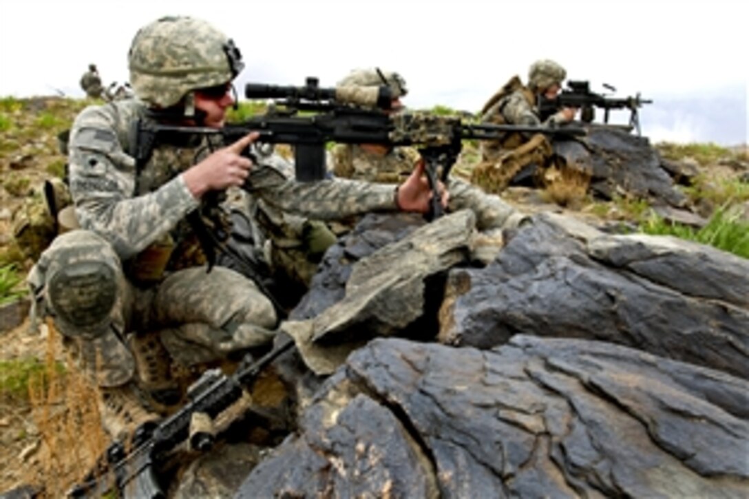 U.S. Army soldiers provide security as a convoy passes through a valley in southern Wardak province, Afghanistan, April 29, 2010. The soldiers are assigned to the 1st Battalion, 503rd Infantry Regiment, 173rd Airborne Brigade Combat Team.