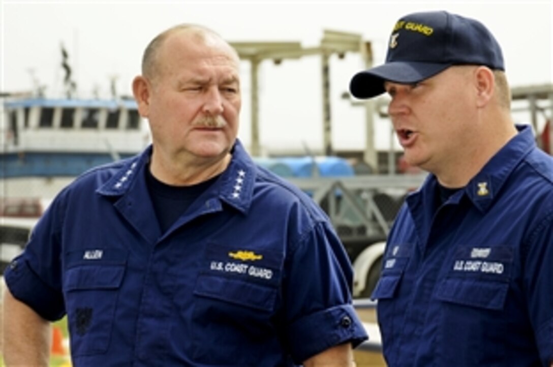 U.S. Coast Guard Master Chief Petty Officer Charles Bushey, officer-in-charge of Coast Guard Station Venice, La., briefs Coast Guard Commandant Adm. Thad Allen, left, before a visit by President Barack Obama in Venice, La., May 2, 2010. 