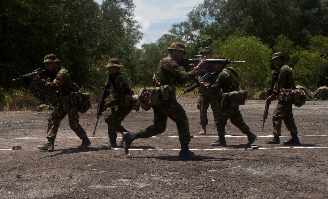 20100503-M-4896B-003 RIMBA AIR BASE, Brunei - A squad of Royal Brunei Landing Force soldiers enter a room, which was identified by tape on the ground, while they practice the fundamentals of Military Operations in Urban Terrain (MOUT). More than 45 Marines from the Landing Force participating in Cooperation Afloat Readiness and Training (CARAT) Brunei 2010 trained with and taught MOUT fundamentals to RBLF soldiers as part of LF CARAT-2010, a series of bilateral exercises held annually in Southeast Asia to strengthen relationships and to enhance force readiness.  (U.S. Marine Corps photo by Lance Cpl. Colby W. Brown).