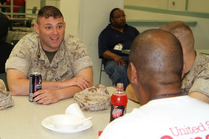Corporal Aaron Frye, a Patricksburg, Ind., native, assigned to Company K, 3rd Battalion, 24th Marine Regiment, enjoys a moment with veterans at the New England Center for Homeless Veterans May 3, 2010.  Marines participated in the community outreach project in support of Marine Week Boston, a weeklong opportunity to increase public awareness of the Marine Corps' value to the nation's defense.