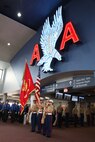 (From left) Lance Cpl. Mike Vandeveer, Sgt. Steven Killburne, Sgt. Edward Merz, Cpl. Nicole Tannehill., colorguardsmen with 3rd Battalion, 24th Marine Regiment stand before the audience at American Airlines' gate dedication ceremony at Logan International Airport, May 3, 2010.  The ceremony dedicated gate B33 to the Marine Corps during Marine Week Boston, May 3-9, 2010.
