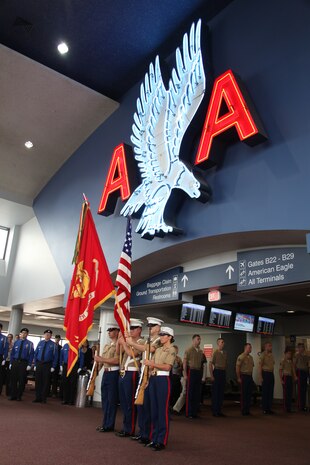 (From left) Lance Cpl. Mike Vandeveer, Sgt. Steven Killburne, Sgt. Edward Merz, Cpl. Nicole Tannehill., colorguardsmen with 3rd Battalion, 24th Marine Regiment stand before the audience at American Airlines' gate dedication ceremony at Logan International Airport, May 3, 2010.  The ceremony dedicated gate B33 to the Marine Corps during Marine Week Boston, May 3-9, 2010.