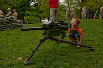Nicholas Martin, a 4-year-old from Medford, Mass., sights in on an MK-19 grenade launcher during an exhibition of crew-served weapons used by Marines at Boston Common May 3. The exhibition was during the first day of Marine Week Boston, which honors and recognizes the contributions of Marines, including Boston-based hometown heroes and their families.