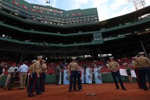 Avid Boston Red Sox fans Gunnery Sgt. Thomas Murphy and his son, Nolan, stand for the first time in Fenway Park grounds just before the Red Sox take on the Anaheim Angels May 3, 2010.