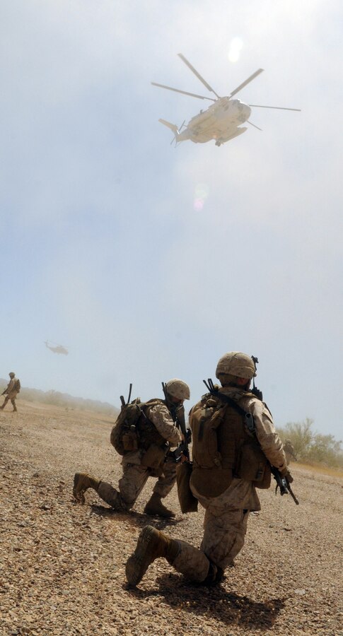 Company B commander 1st Lt. Tyler Tidwell, with 1st Battalion, 1st Marine Regiment, establishes contact with his troops after landing during a helicopter-borne raid on a simulated insurgent camp in the Chocolate Mountains in California, May 3, 2010. Inserting in four different locations, via MV-22 Ospreys, CH-46 Sea Knights and CH-53 Super Stallions, Companies B and C, along with the Weapons Company, assaulted the camp with small-arms fire and rockets. Here supporting the current Weapons and Tactics Instructor course, the Camp Pendleton, Calif.-based unit is also training for a deployment early next year with the 13th Marine Expeditionary Unit.