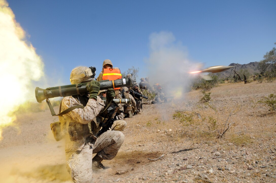 Lance Cpl. Jorge Salazar with Company B, 1st Battalion, 1st Marine Regiment, launches a rocket from an AT-4 during a helicopter-borne raid on a simulated insurgent camp in the Chocolate Mountains in California, May 3, 2010. Inserting in four different locations, via MV-22 Ospreys, CH-46 Sea Knights and CH-53 Super Stallions, Companies B and C, along with the Weapons Company, assaulted the camp with small-arms fire and rockets. Here supporting the current Weapons and Tactics Instructor course, the Camp Pendleton, Calif.-based unit is also training for a deployment early next year with the 13th Marine Expeditionary Unit.