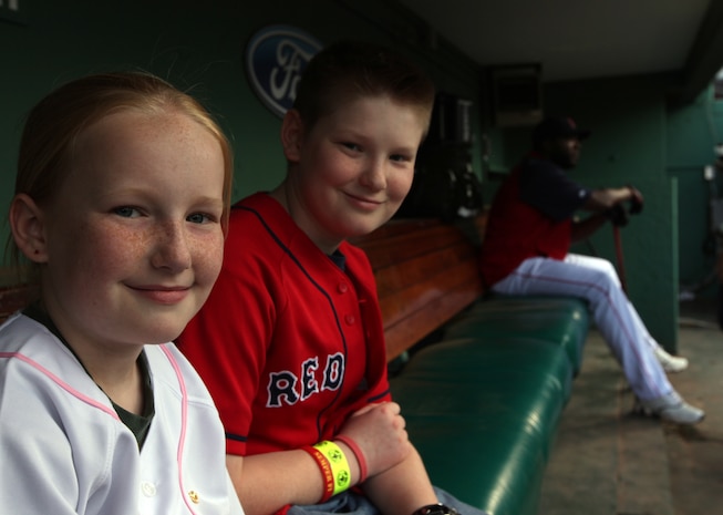 Jake and Shaelin Murphy, the son and daughter of Maj. Neil Murphy of New York City Public Affairs can't help but be happy to be sharing the bench with Red Sox designated hitter David Ortiz at Fenway Park May 3, 2010, just before they stepped up to their job as honorary bat boy and bat girl.