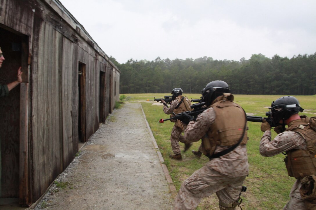 Marines with MP Co., 2nd MAW, practice their urban combat techniques during a field training exercise at Camp Lejeune, May 4. ::r::::n::“I was really excited to get stationed with a field MP unit,” said Lance Cpl. David B. Mitchell, a military policeman who joined MP Co. about a month ago. “Most of our job field is with the provost marshal’s office. Many at occupational school didn’t even know this existed.”::r::::n::