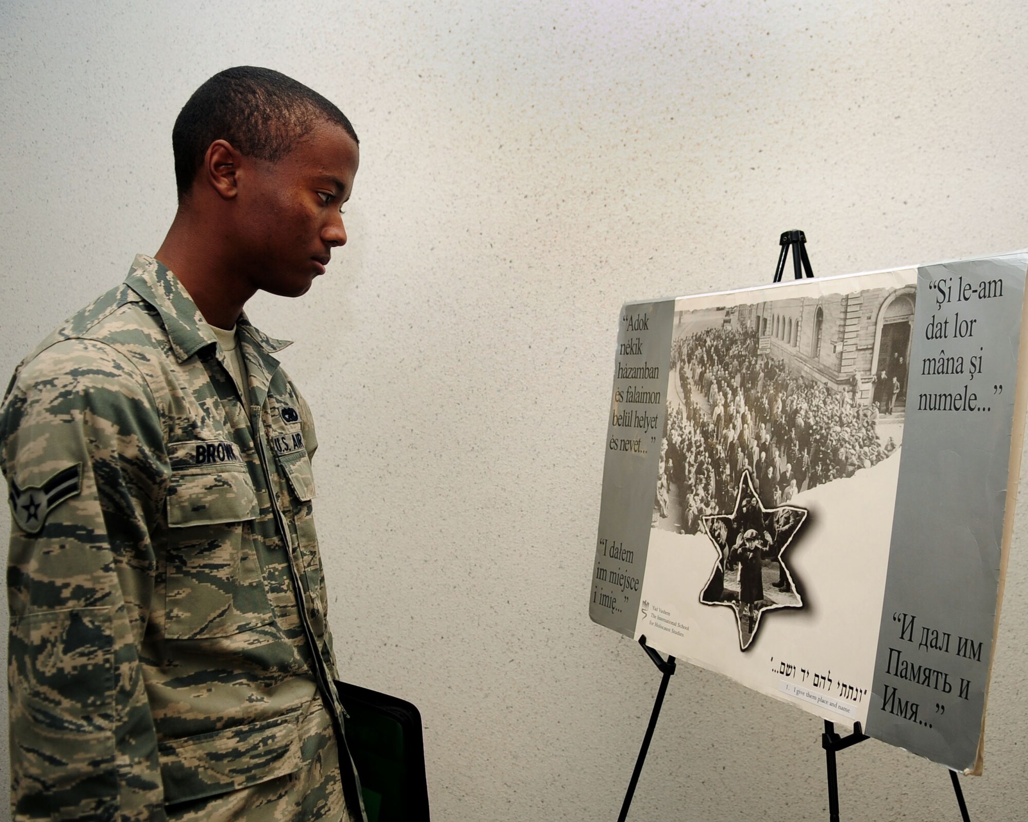Airman 1st Class Oliver Brown, 355th Aircraft Maintenance Squadron, looks at posters highlighting the challenges and struggles during World War II and the Holocaust at the Professional Development Center here May 3. The Davis-Monthan Holocaust Day of Remembrance event was sponsored by the 355th Fighter Wing, and featured WWII and Holocaust survivors who shared personal stories of their sacrifices and survival. (U.S. Air Force photo/Airman Jerilyn Quintanilla)