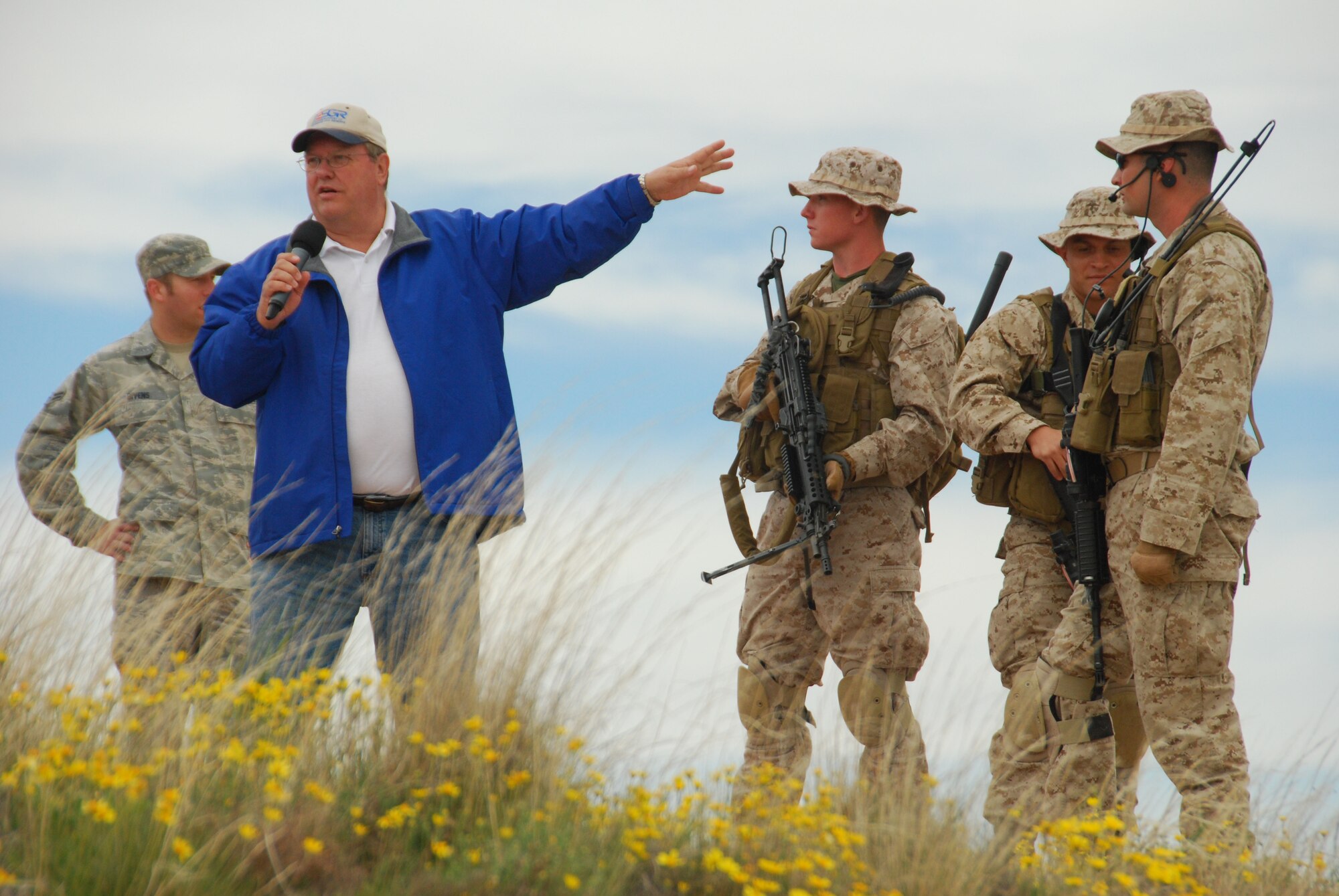 Gary Kaiser, Employer Support of the Guard and Reserve Program Support Specialist, describes the role of the Marines of Delta Company, 4th Marine Reconnaissance Battalion standing next to him during the ESGR "Boss Lift" May 1. The annual event at Melrose Air Force Range included an F-16 aerial bombing demonstration, helicopter air assault and simuluated  pilot rescue by members of the New Mexico National Guard and Reserve units. (U.S. Air Force photo by 2nd Lt. Stephanie Strine)