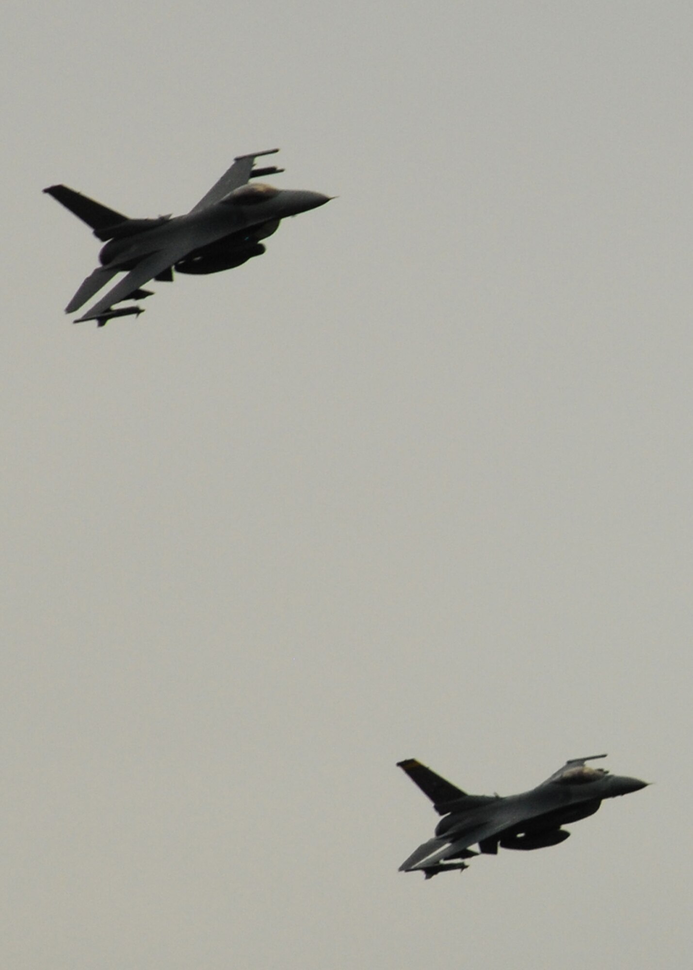 Two F-16 Fighting Falcons from the New Mexico Air National Guard fly over the Melrose Range for the Employer Support of the Guard and Reserve "Boss Lift" May 1. A team of Marine Reserve Joint Terminal Attack Controllers called in targets from the ground in an aerial bombing demonstration for a crowd of more than 50 people. (U.S. Air Force photo by 2nd Lt. Stephanie Strine)
