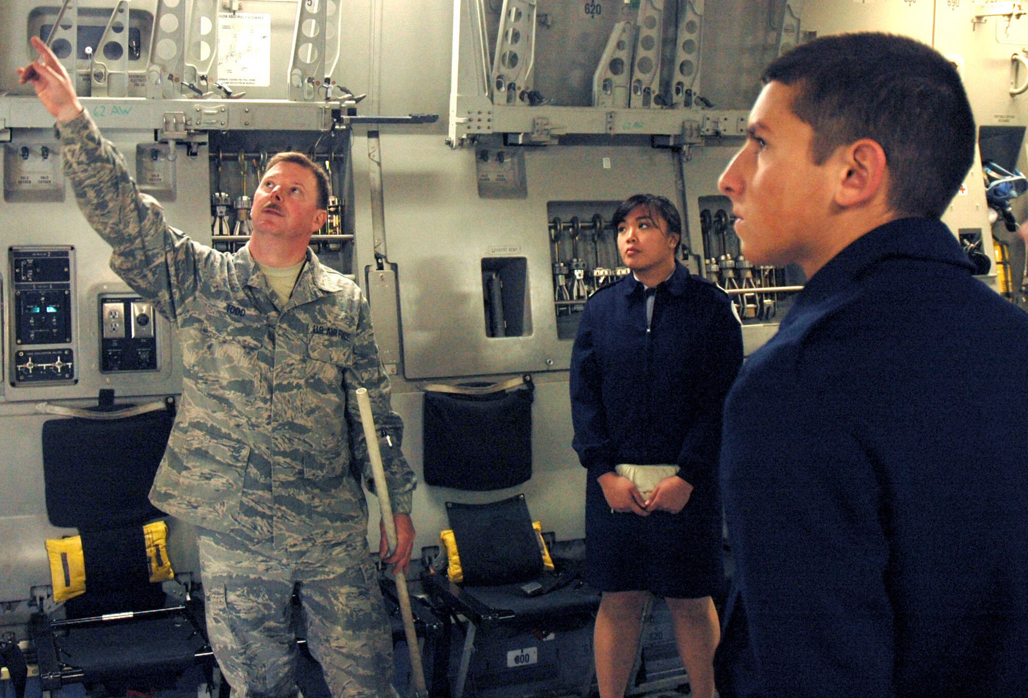 JOINT BASE LEWIS-MCCHORD, Wash. - Master Sgt. Jack Todd, flightline maintenance expediter, 446th Aircraft Maintenance Squadron, explains the C-17 Globemaster III aircraft's overhead specifications during the Todd Beamer High School Junior ROTC job shadow at McChord Field here, May 1. The job shadow is an annual event coordinated by the 446th Airlift Wing, that gives cadets a first-hand look at careers in the Air Force Reserve and a better understanding of the 446th AW's mission. After the C-17 tour, sponsors took their cadets around their respective shops, where they took part in squadron-specific activities. (U.S. Air Force photo/Staff Sgt. Nicole Celestine)