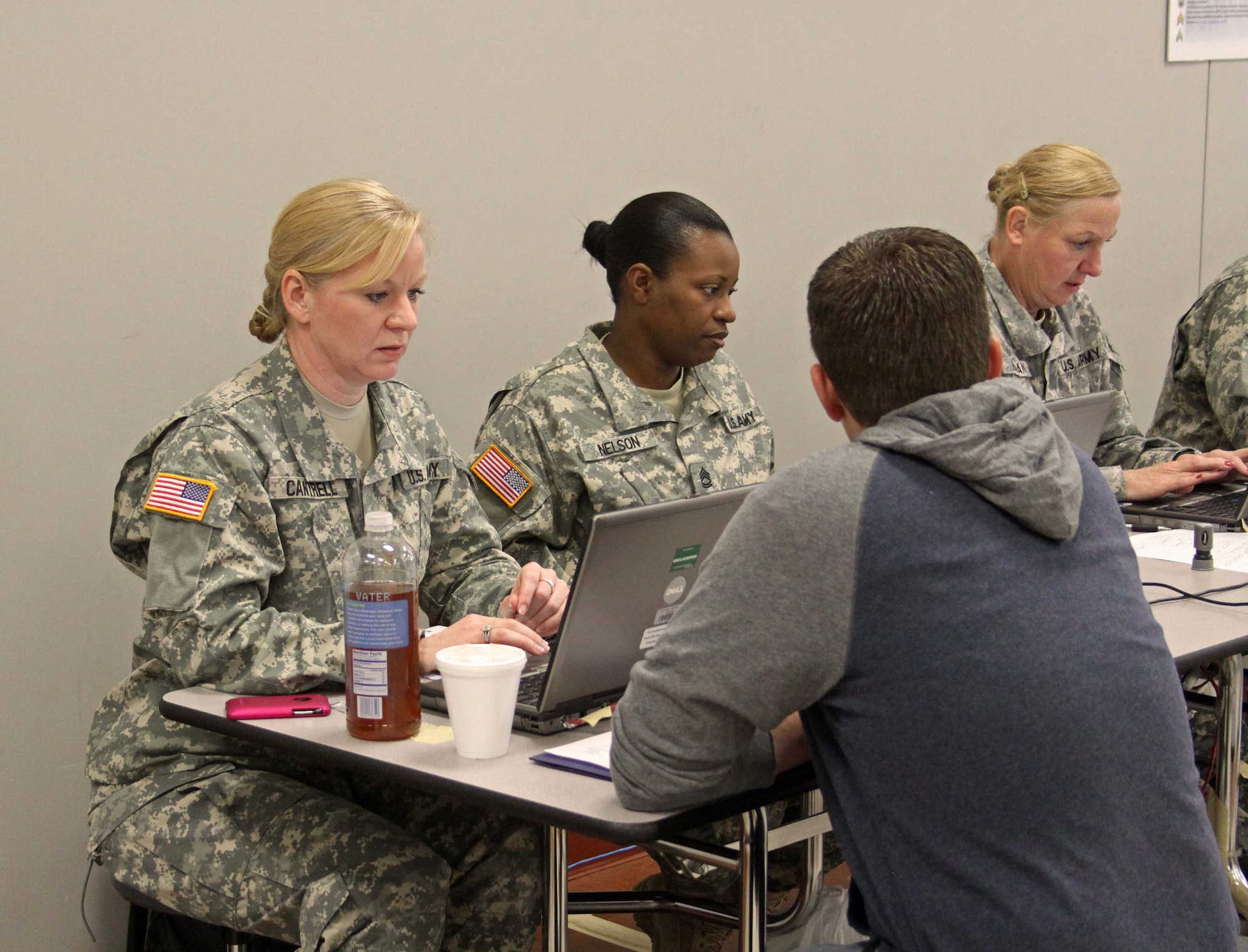 Maj. Hollis Cantrell, HRC career manager, verifies an Individual Ready Reserve Soldier’s retirement points during an IRR Readiness Muster at Newtown Square Army Reserve Center April 25. (U.S. Army photo/Staff Sgt. Alyn Macleod)