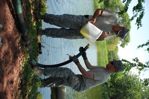 Technical Sgt. William Mock and Staff Sgt. John Seifert, both from Army Forces' Petroleum, Oils and Lubricants Section, pour pond water into a Reverse Osmosis Water Purification Unit during training at Soto Cano Air Base, Honduras, May 4. Instructors from Ft. Lee, Va., are conducting a course here May 3-7, teaching JTF-Bravo members how to operate the ROWPU, which can be used to provide drinkable water from any water source. JTF-Bravo maintains ROWPU capability in order to assist in disaster relief situations where clean drinking water is needed. (U.S. Air Force photo by 1st Lt. Jen Richard)