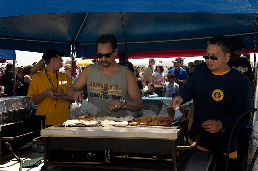 Vendors grill burgers for spectators at the March Field AirFest, March Air Reserve Base, Calif., May 1, 2010. March Field AirFest is a two-day event featuring performances and static displays of civilian and military aircraft. (U.S. Air Force photo by Tech. Sgt. Carolyn Erfe/Released)
