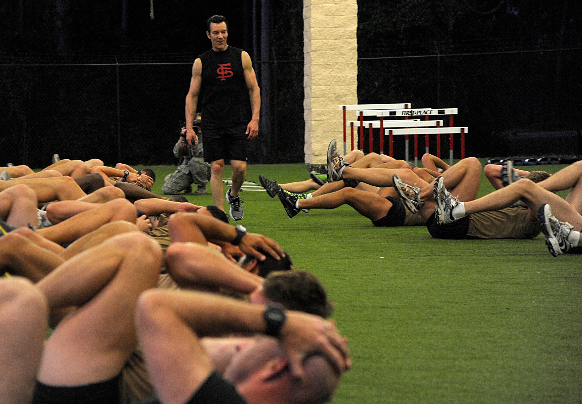 Tony Horton, creator of the P90X, and participant of the Joint Civilian Orientation Course (JCOC) runs the Special Tactics Training Squadron students through a workout on April 29, 2010 at Hurlburt Field, Fla. JCOC is a Secretary of Defense sponsored program, which gives civilian community leaders the opportunity to learn about the military and national defense. (U.S. Air Force photo by Master Sgt. Russell E. Cooley IV)(Released)

