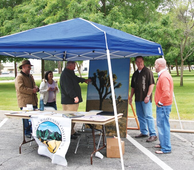 March Earth Day organizers Gerald Haas, left, Paul Pitman, third from left, and Carroll Hale, second from right, joke with the California Wilderness Coalition's Marisa Calderon, second from right, and Mark Starr from the Vet Voice Foundation. (U.S. Air Force photo by Megan Just)