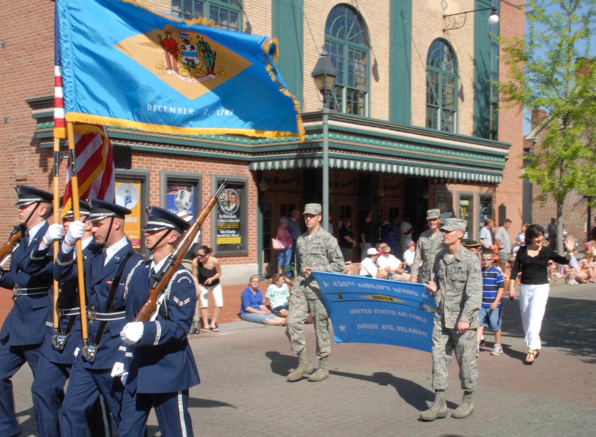 The Dover Honor Guard lead the way followed by Airman 1st Class C.J. Rowland and Alexander Doyle, who carried the 436th Airlift Wing banner during the Dover Days Parade May 1.  (U.S. Air Force photo/Staff Sgt. Chad Padgett)