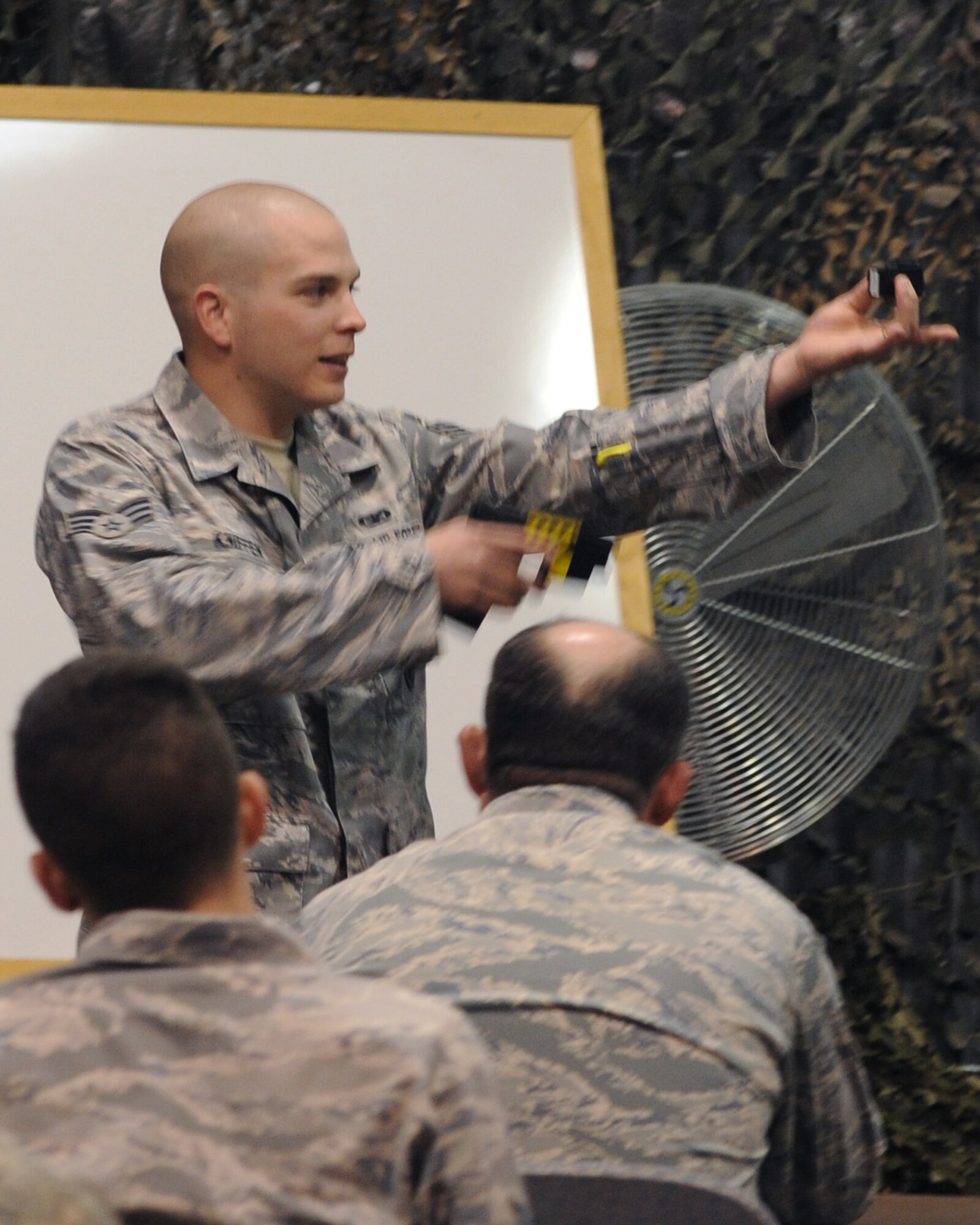 Senior Airman Matthew Kniffen, 319th Security Forces Squadron, instructs personnel on the proper use of the M26 Taser on Grand Forks Air Force Base, N.D. All SFS members must fire at least two taser cartridges for certification during their annual training. (U.S. Air Force photo by Airman 1st Class Amber Price)