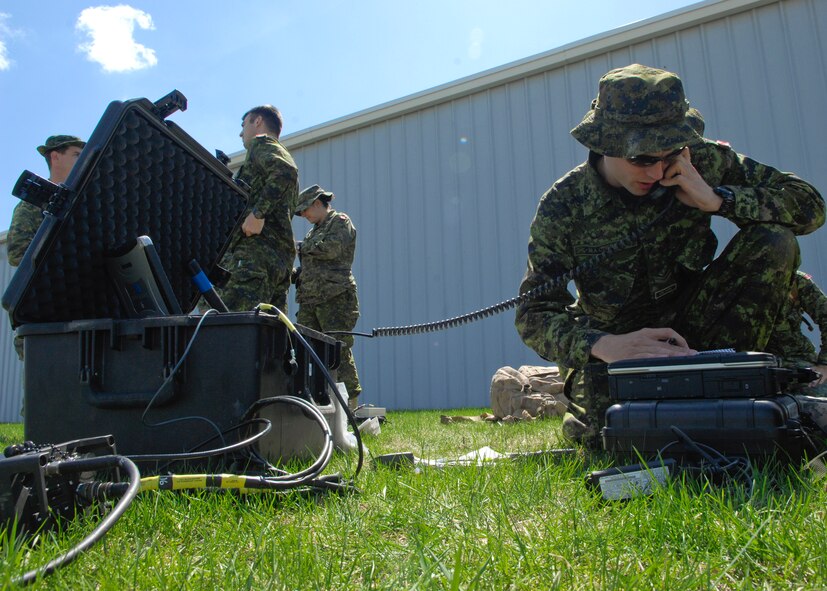 MINOT, N.D. – Master Bombardier Michael MacIntyre, member of the Canadian Forces Base Shilo, uses a rover to call in the location of a target discuss training procedures during a Joint Terminal Attack Controller training held here April 27 and 28. The training was part of a joint effort to maintain proficiency and increase familiarization of both Canadian and American procedures. (U.S. Air Force photo by Senior Airman Ashley N. Avecilla)