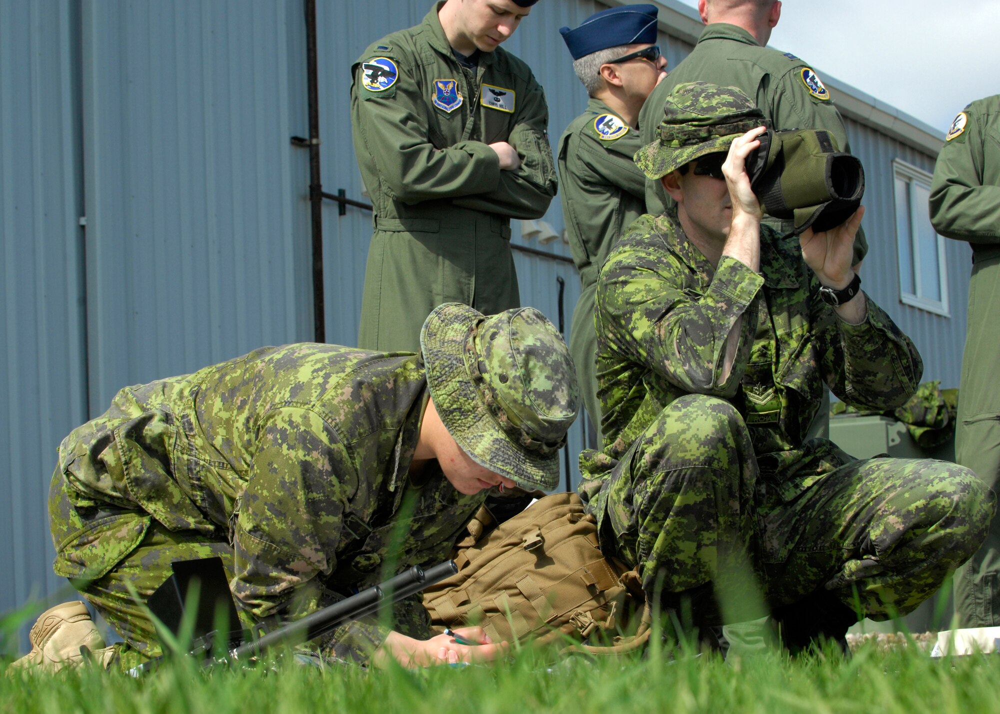 MINOT, N.D. -- Capt. Kandice Dunn and Master Bombardier James Urhoe, members of the Canadian Forces Base Shilo, calculate locations of possible targets during a Joint Terminal Attack Controller training held here April 27 and 28. The training was part of a joint effort to maintain proficiency and increase familiarization of both Canadian and American procedures. (U.S. Air Force photo by Senior Airman Ashley N. Avecilla)