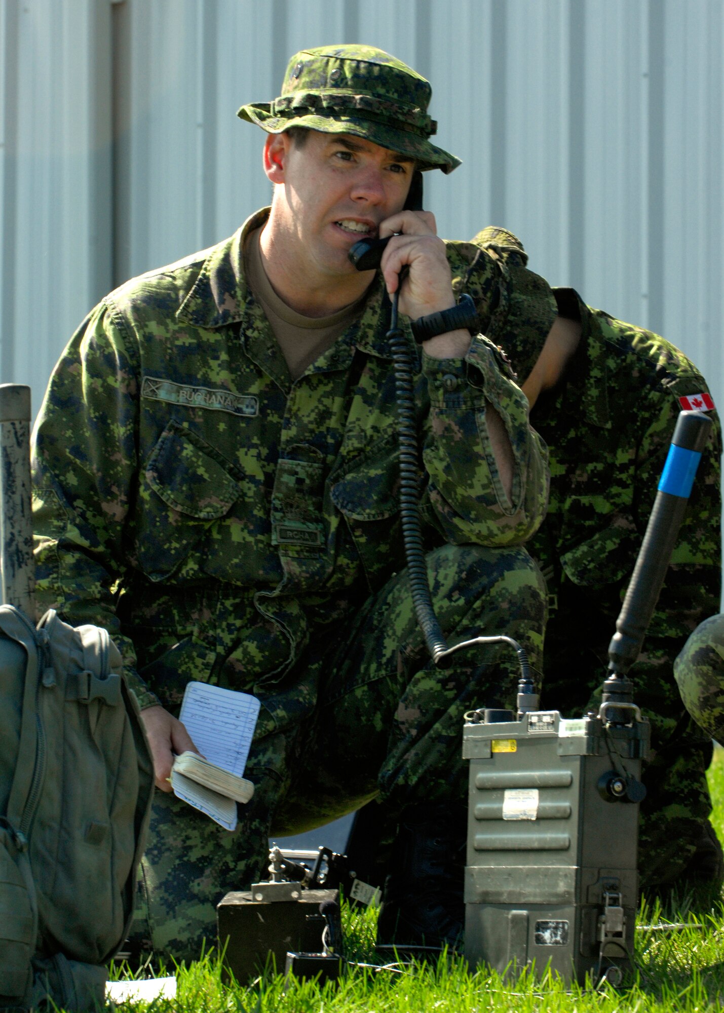 MINOT, N.D. -- Warrant Officer Todd Buchanan, member of the Canadian Forces Base Shilo, reports on “insurgents” during a Joint Terminal Attack Controller training held here April 27 and 28. The training was part of a joint effort to maintain proficiency and increase familiarization of both Canadian and American procedures. (U.S. Air Force by Senior Airman Ashley N. Avecilla)