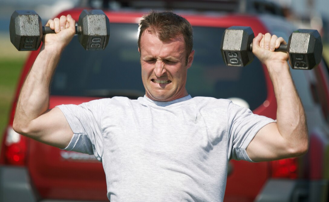 LANGLEY AIR FORCE BASE, Va. -- Maj. Russell Hall lifts dumbbells during the 1st Operations Support Squadron's combat fitness course. The course includes several stations, incoporating cardio, strength and endurance training to provide a full-body workout. (U.S. Air Force photo/Tech. Sgt. Jason Harper)