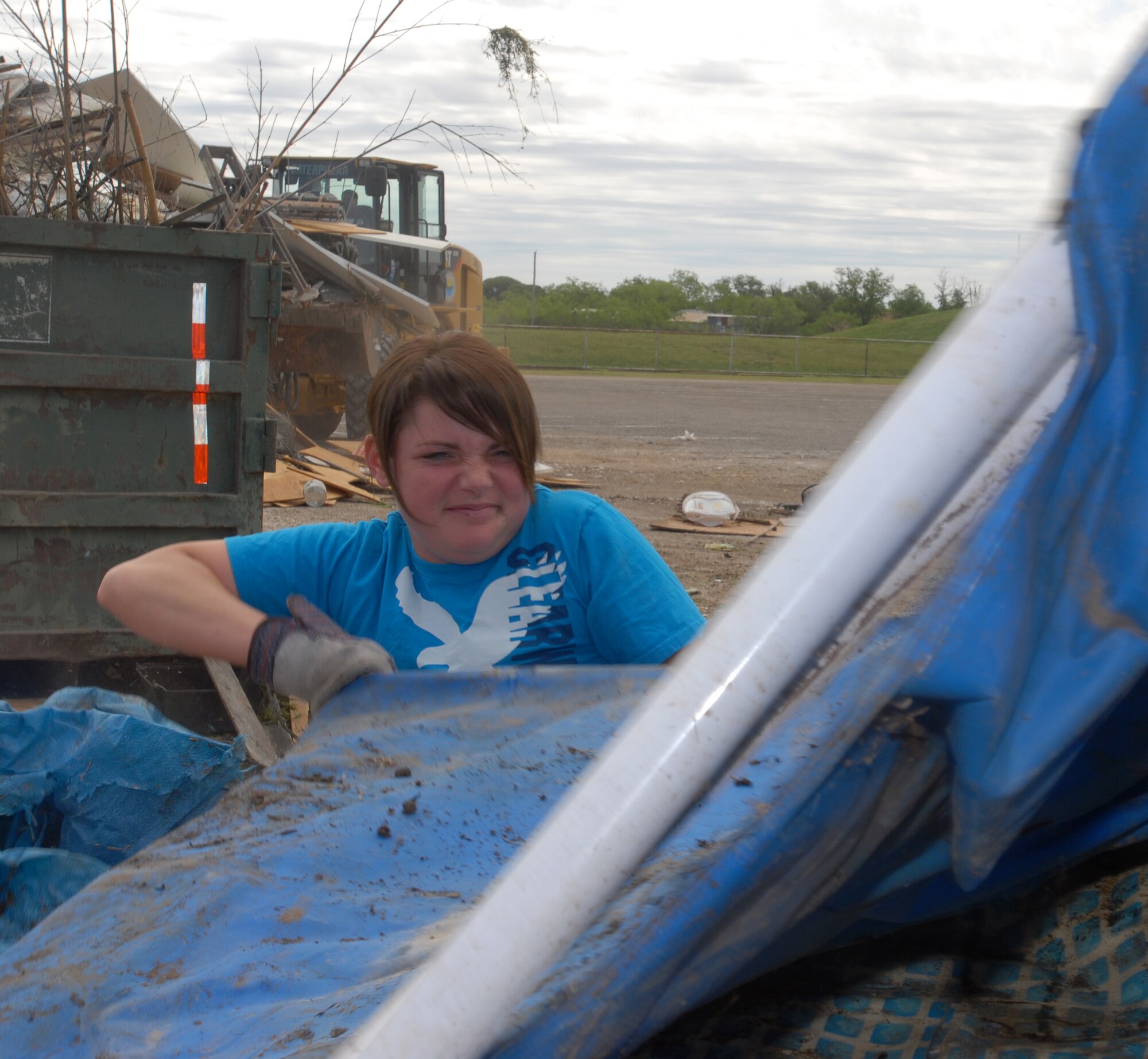 Airman 1st Class Samantha Engeler, 312th Training Squadron unloads a trailer during the Great American Cleanup at the San Angelo Coliseum May 1.  Twice a year San Angelo and Keep San Angelo Beautiful, with the help of volunteers from Goodfellow, participate in the Great American Cleanup.   The community effort spans the country with the intent of reducing trash by recycling waste materials versus adding more material to local landfills. (U.S. Air Force photo/ Master Sgt Randy Mallard)