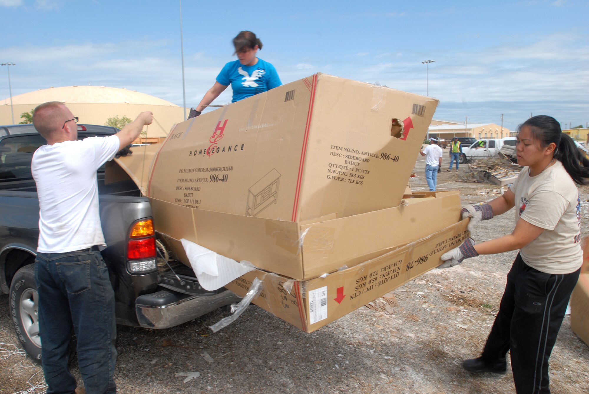 Senior Airman Daniel Letchworth, 17th Communications Squadron, Airman 1st Class Samantha Engeler, 312th Training Squadron, and Airman 1st Class Junille Leon-Guerrero, 312th Training Squadron, unload a pick up bed full of cardboard boxes during the Great American Cleanup at the San Angelo Coliseum May 1.  Twice a year San Angelo and Keep San Angelo Beautiful, with the help of volunteers from Goodfellow, participate in the Great American Cleanup.  The community effort spans the country with the intent of reducing trash by recycling waste materials versus adding more material to local landfills. (U.S. Air Force photo/ Master Sgt Randy Mallard)