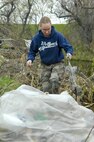 MINOT, N.D. -- Senior Airman Miranda Harris, 742nd Missile Squadron missile chef, picks up trash in a creek bed near the Dakota Square Mall here April 30. Team Minot joined together in an effort to clean up the city. A trash-free city is a sure way kids of all ages can enjoy the summer months after a long, hard North Dakota winter. (U.S. Air Force photo by Senior Airman Benjamin Stratton)