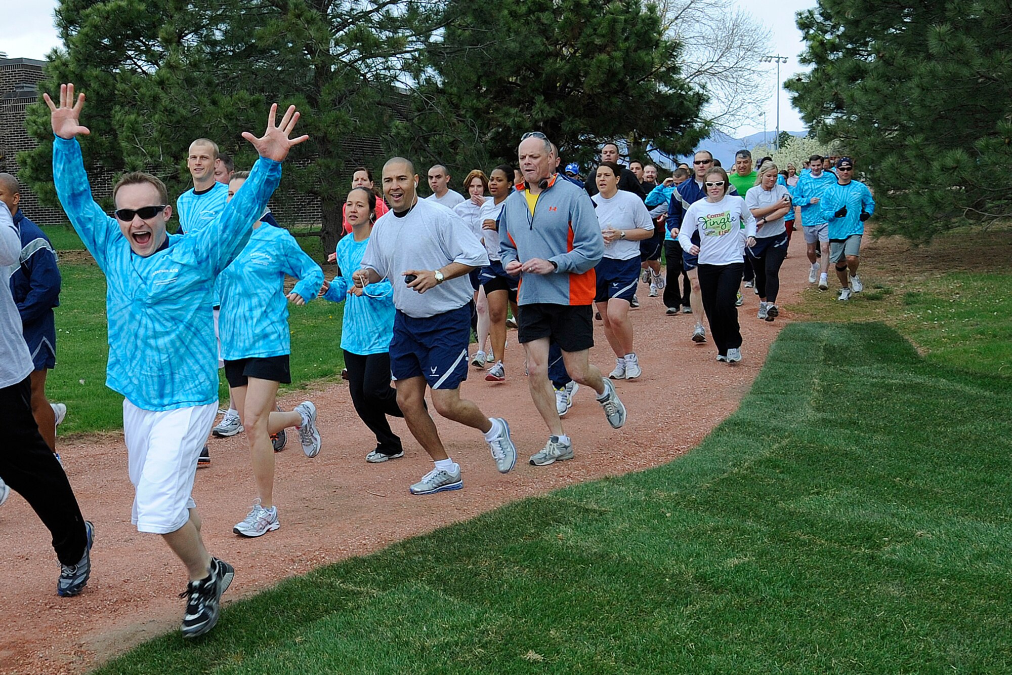 PETERSON AIR FORCE BASE, Colo. – More than 140 Team Pete personnel race in the Sexual Assault Awareness Month five-kilometer run behind the Peterson AFB fitness center April 30. One of the goals of Sexual Assault Prevention and Response is to educate the base community on sexual assault issues through instruction. Coming in first at the run was Senior Master Sgt. Michael Woods, U.S. Air Force Academy Band, with a time of 20:06. The run was one of several events in April, including special guest speakers Kelly and Becca and a self defense class, to promote the SAPR programs offered on Peterson. (U.S. Air Force photo/Craig Denton)