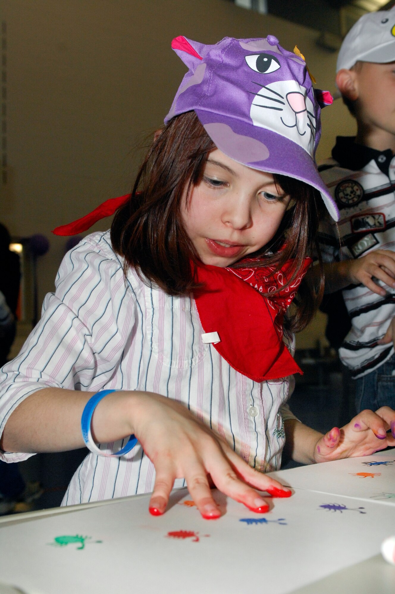 MINOT AIR FORCE BASE, N.D. – Grace Rockwell, daughter of Staff Sgt. Lucian Rockwell, 5th Aircraft Maintenance Squadron communication navigation mission systems craftsman, finger paints during the Kid’s Block Party at the David C. Jones Youth Center here April 30. The Block Party included games, gifts, crafts and other activities for children of military members. (U.S. Air Force photo by Senior Airman Jesse Lopez)