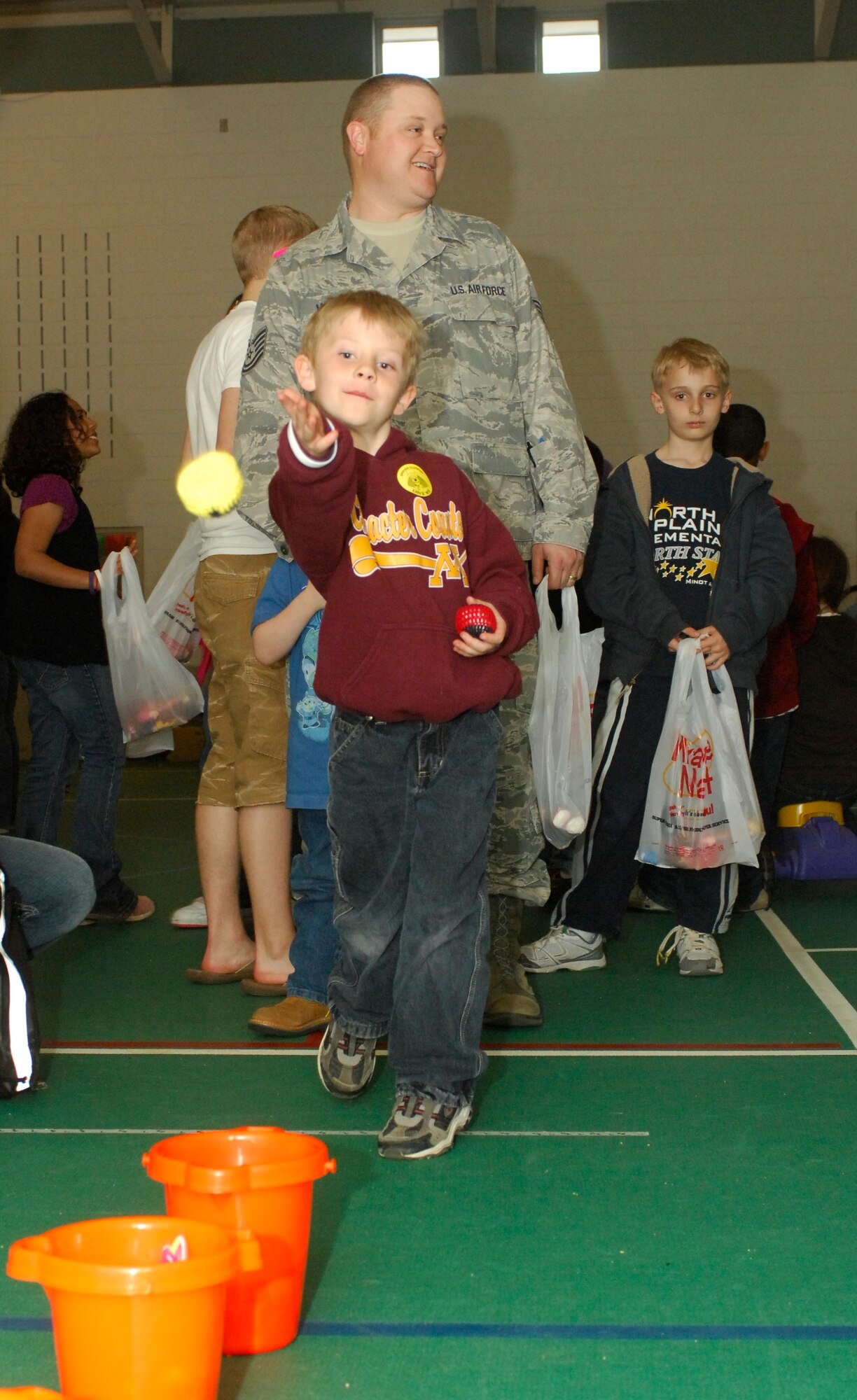 MINOT AIR FORCE BASE, N.D. – Jonathon Genetti, son of Master Sgt. Andrew Genetti, 91st Missile Security Forces Squadron flight chief plays a bean bag game during the Kid’s Block Party at the David C. Jones Youth Center here April 30. The Block Party included games, gifts, crafts and other activities for children of military members. (U.S. Air Force photo by Senior Airman Jesse Lopez)