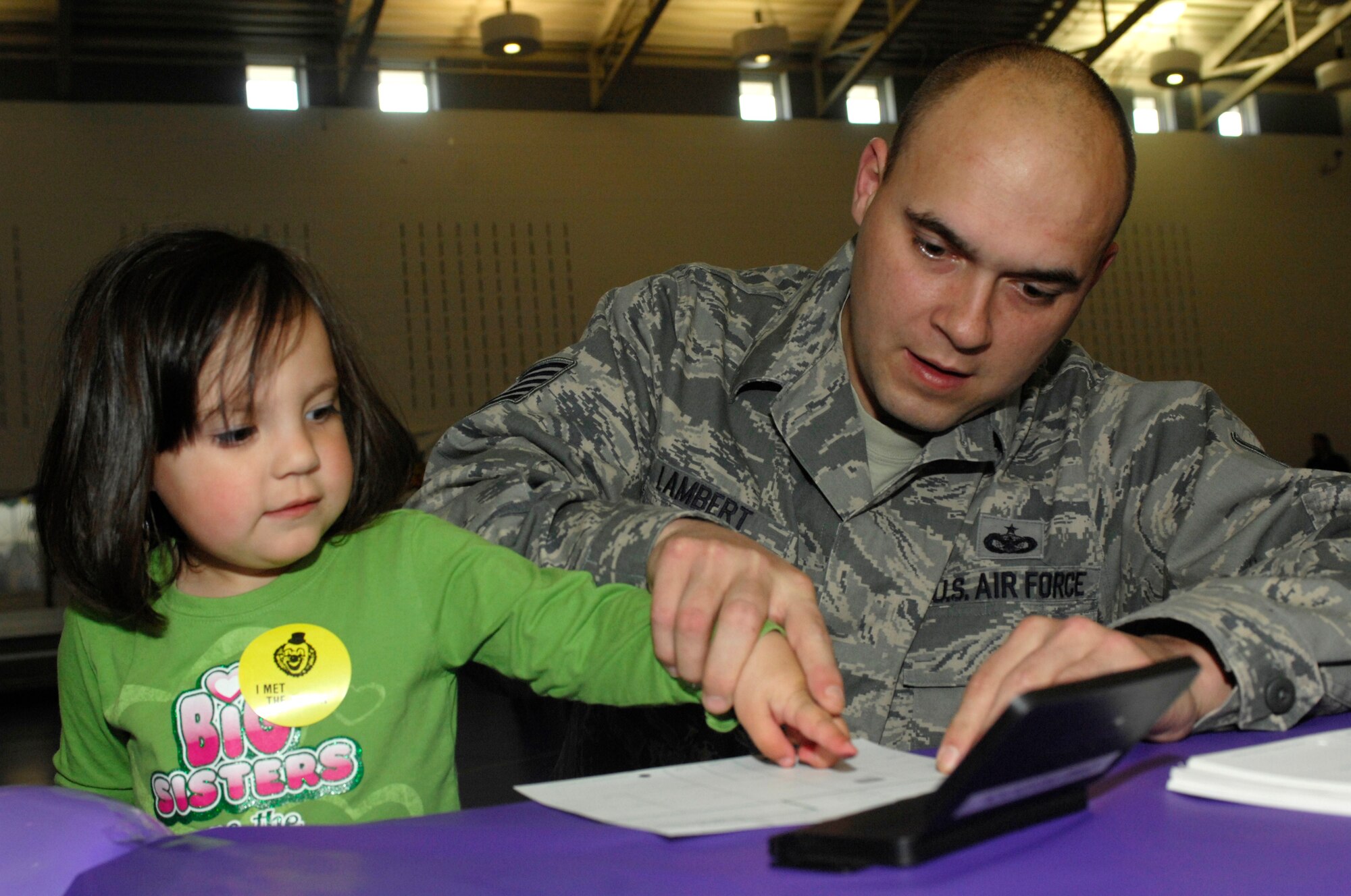 MINOT AIR FORCE BASE, N.D. – Cayden Thoms, daughter of Master Sgt. Scott Thoms, 91st Missile Maintenance Squadron quality assurance supervisor, finger paints during the Kid’s Block Party at the David C. Jones Youth Center here April 30. The Block Party included games, gifts, crafts and other activities for children of military members. (U.S. Air Force photo by Senior Airman Jesse Lopez)