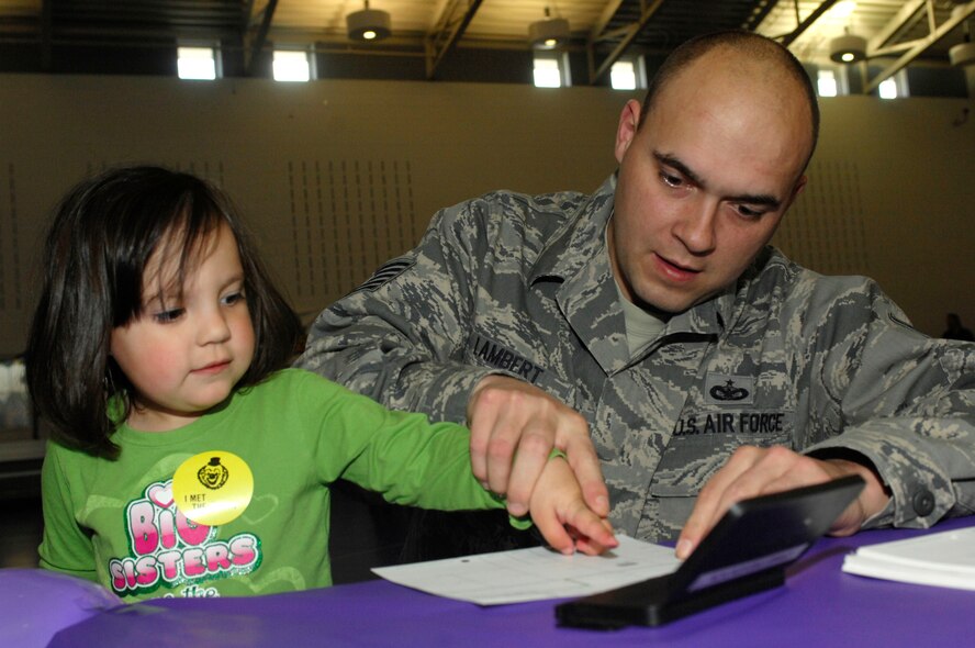 MINOT AIR FORCE BASE, N.D. – Cayden Thoms, daughter of Master Sgt. Scott Thoms, 91st Missile Maintenance Squadron quality assurance supervisor, finger paints during the Kid’s Block Party at the David C. Jones Youth Center here April 30. The Block Party included games, gifts, crafts and other activities for children of military members. (U.S. Air Force photo by Senior Airman Jesse Lopez)