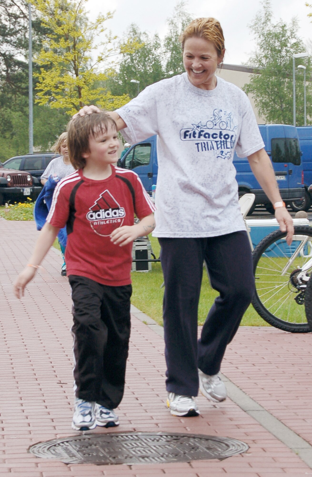 Laura Mitvalsky congratulates her son Eric Echtermeyer, 6, after completing the running portion of the second annual FitFactor Triathlon May 2, 2010, at Ramstein Air Base, Germany. Ms. Mitvalsky and her two children called themselves "Team FIT" (family in training) and each competed in a different portion of the event. Ms. Mitvalsky is assigned to the U.S. Army Public Health Command. (U.S. Air Force photo/Senior Airman Amanda Dick)